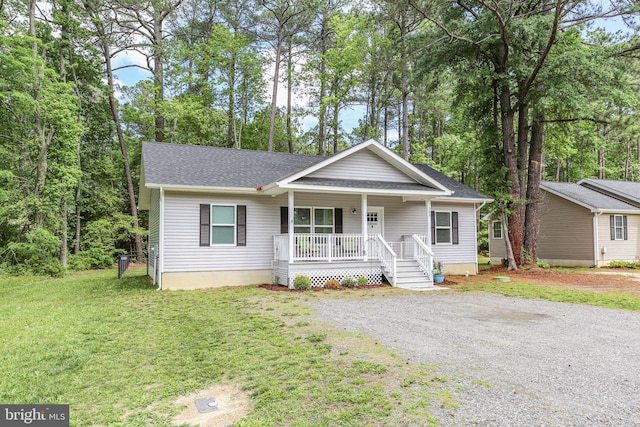309 N Glebe Rd, Montross, VA 22520 - view of front of house featuring a porch, a front yard, and a shingled roof