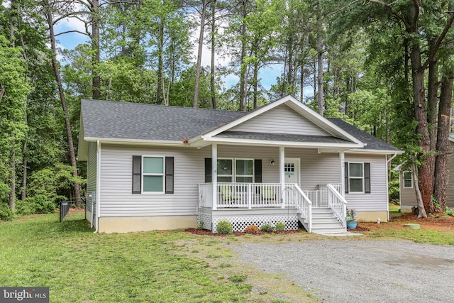 309 N Glebe Rd, Montross, VA 22520 - view of front of house with covered porch, roof with shingles, and a front yard