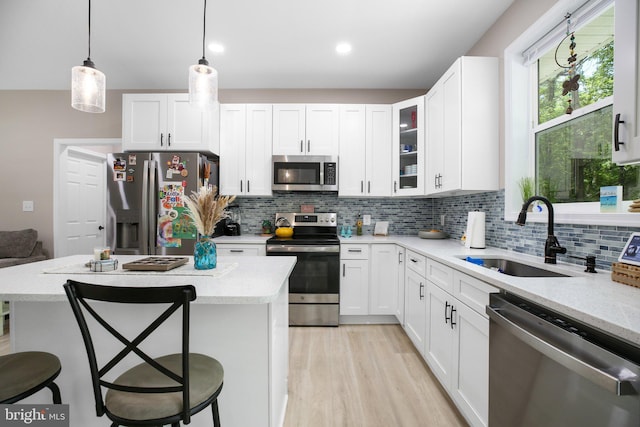 309 N Glebe Rd, Montross, VA 22520 - kitchen featuring appliances with stainless steel finishes, a sink, a breakfast bar, white cabinetry, and light stone countertops