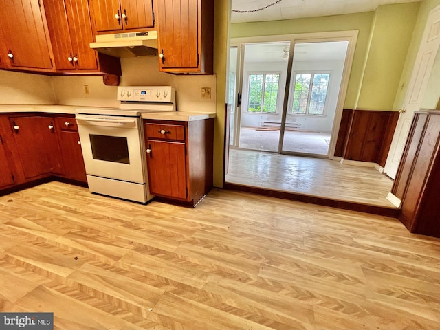 203 N Cedar St, Lititz, PA 17543 - kitchen featuring white electric stove, under cabinet range hood, light wood finished floors, and light countertops