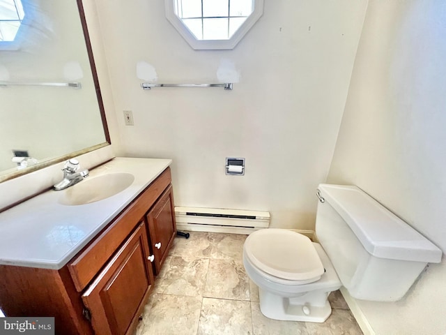 203 N Cedar St, Lititz, PA 17543 - bathroom with baseboard heating, a skylight, toilet, vanity, and baseboards