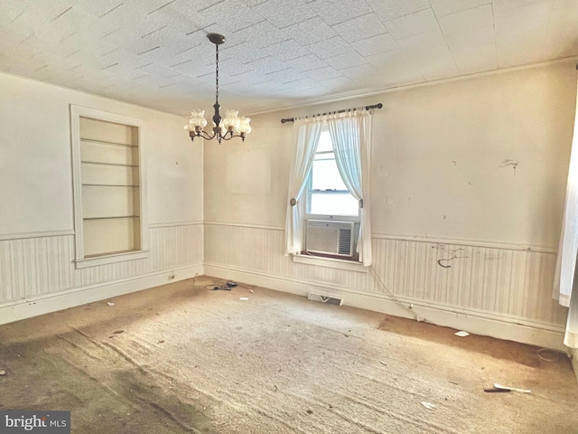 203 N Cedar St, Lititz, PA 17543 - carpeted empty room with a chandelier, wainscoting, built in features, and cooling unit