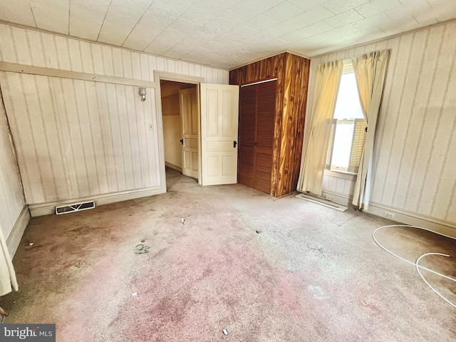 203 N Cedar St, Lititz, PA 17543 - unfurnished bedroom with wooden walls, carpet flooring, and a closet