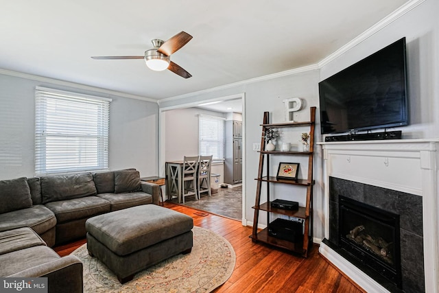 1906 Jackson Rd, Baltimore, MD 21222 - living room with crown molding, hardwood / wood-style floors, a ceiling fan, and a tiled fireplace