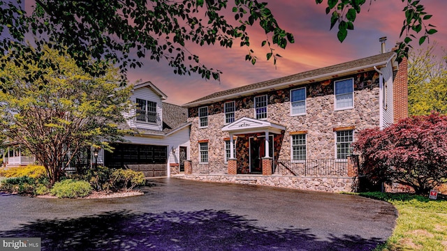 7140 Poole Jones Rd, Frederick, MD 21702 - view of front of property featuring stone siding, driveway, and a garage