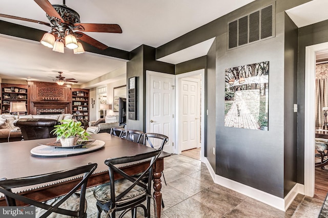 7140 Poole Jones Rd, Frederick, MD 21702 - tiled dining room with a ceiling fan, a brick fireplace, and baseboards