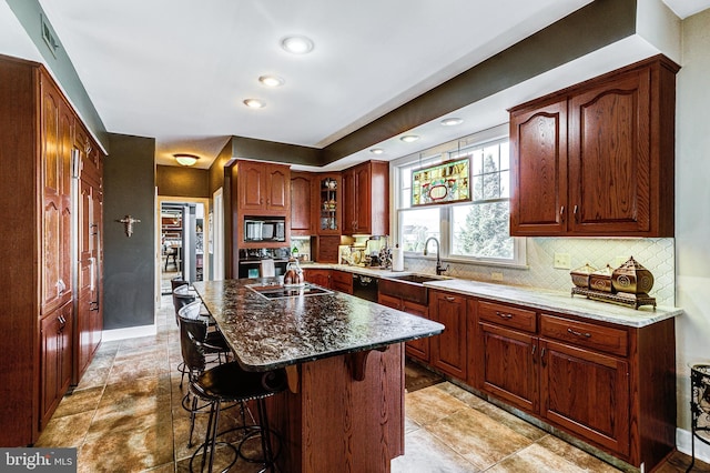 7140 Poole Jones Rd, Frederick, MD 21702 - kitchen with a sink, black appliances, a breakfast bar, decorative backsplash, and recessed lighting