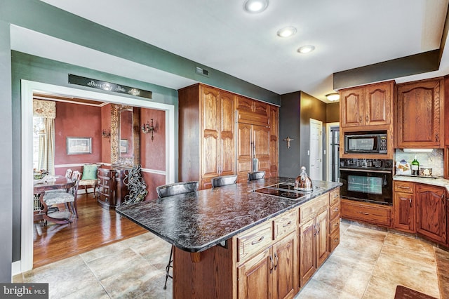 7140 Poole Jones Rd, Frederick, MD 21702 - kitchen with black appliances, a center island, a kitchen breakfast bar, brown cabinets, and recessed lighting