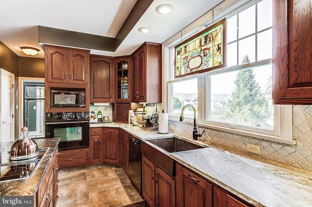 7140 Poole Jones Rd, Frederick, MD 21702 - kitchen featuring black appliances, a sink, light stone countertops, backsplash, and glass insert cabinets