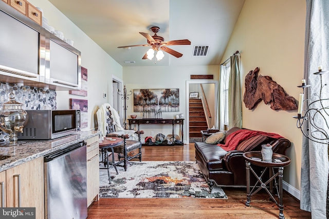 7140 Poole Jones Rd, Frederick, MD 21702 - living area featuring wood finished floors, ceiling fan, stairway, and baseboards
