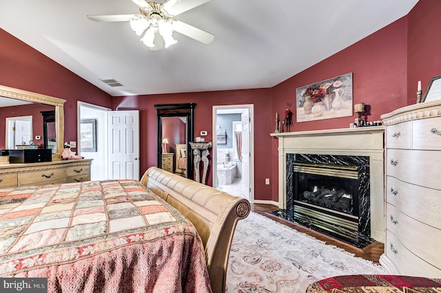 7140 Poole Jones Rd, Frederick, MD 21702 - bedroom with vaulted ceiling, a high end fireplace, wood finished floors, ensuite bathroom, and a ceiling fan