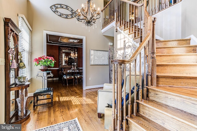 7140 Poole Jones Rd, Frederick, MD 21702 - foyer with stairway, a chandelier, wood finished floors, baseboards, and a towering ceiling