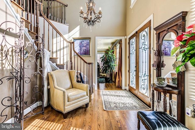 7140 Poole Jones Rd, Frederick, MD 21702 - foyer entrance featuring a chandelier, stairway, wood finished floors, a high ceiling, and french doors