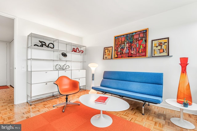 living area featuring baseboards