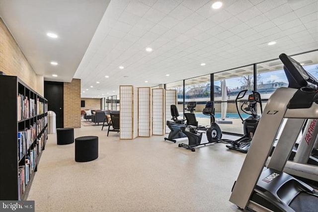 workout area with floor to ceiling windows and recessed lighting