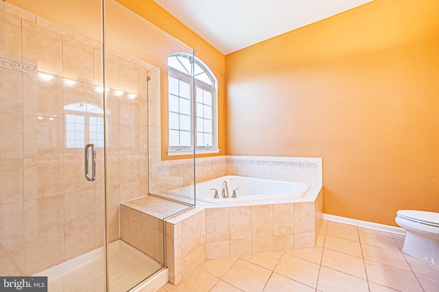 full bathroom featuring tile patterned flooring, a stall shower, a bath, toilet, and vaulted ceiling