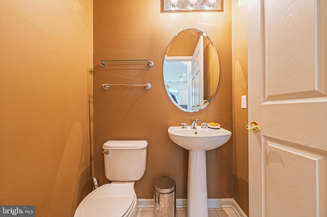 half bath with toilet and a sink