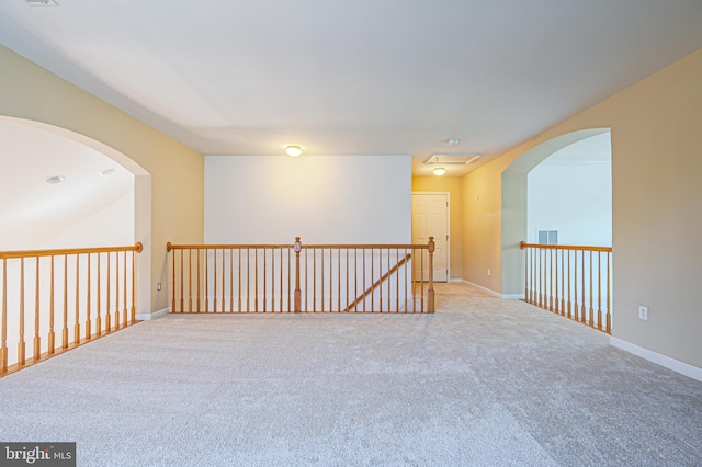 unfurnished room with carpet flooring and baseboards