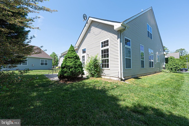 view of side of home featuring a yard