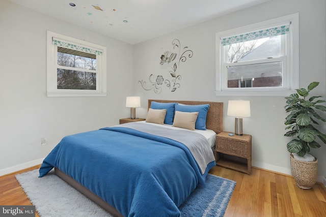 1305 S Buchanan St S, Arlington, VA 22204 - bedroom featuring multiple windows, wood finished floors, and baseboards