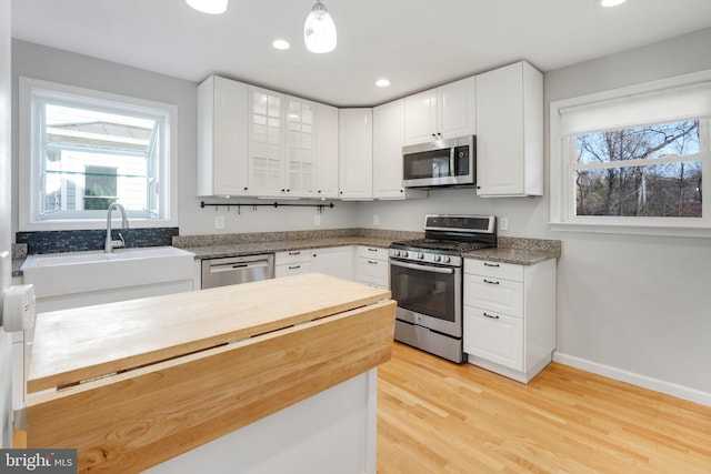 1305 S Buchanan St S, Arlington, VA 22204 - kitchen featuring appliances with stainless steel finishes, plenty of natural light, light wood-type flooring, white cabinetry, and recessed lighting