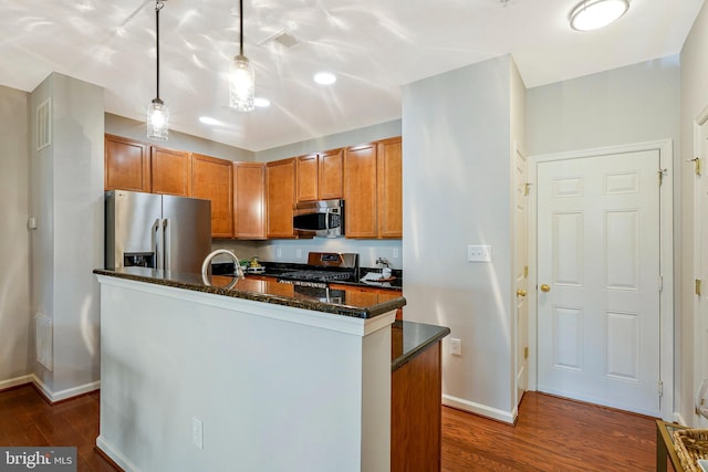 6055 Wicker Ln Unit 127, Centreville, VA 20121 - kitchen featuring appliances with stainless steel finishes, dark wood-style floors, baseboards, brown cabinetry, and decorative light fixtures