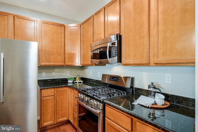 6055 Wicker Ln Unit 127, Centreville, VA 20121 - kitchen featuring appliances with stainless steel finishes, wood finished floors, and dark stone countertops