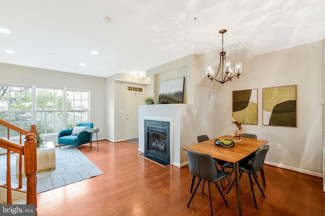 6055 Wicker Ln Unit 127, Centreville, VA 20121 - dining room featuring wood finished floors, baseboards, a chandelier, a fireplace with flush hearth, and recessed lighting