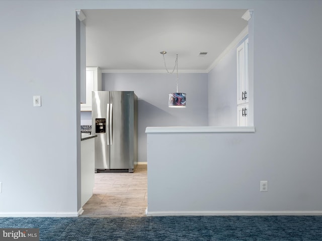 1110 Huntmaster Ter NE Unit 302, Leesburg, VA 20176 - kitchen with stainless steel refrigerator with ice dispenser, white cabinets, crown molding, and baseboards