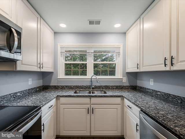 1110 Huntmaster Ter NE Unit 302, Leesburg, VA 20176 - kitchen with stainless steel appliances, a sink, white cabinets, recessed lighting, and dark stone counters