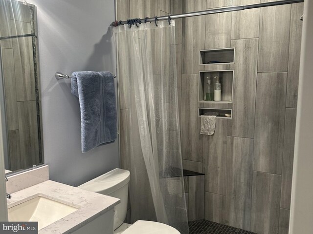 1110 Huntmaster Ter NE Unit 302, Leesburg, VA 20176 - bathroom with toilet, vanity, and tiled shower