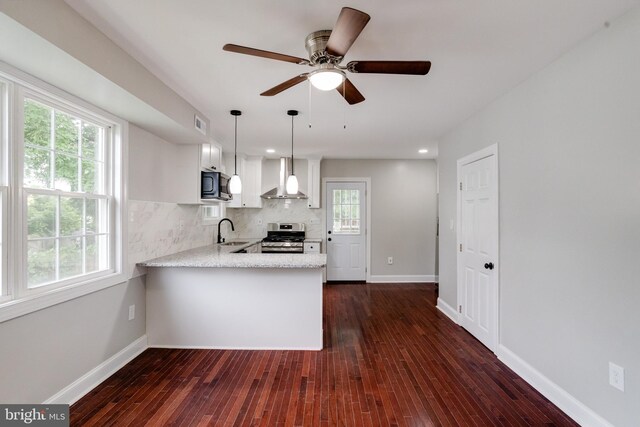 3411 Roselawn Ave, Baltimore, MD 21214 - kitchen with stainless steel gas range, a sink, wall chimney range hood, a peninsula, and dark wood-style flooring