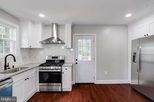 3411 Roselawn Ave, Baltimore, MD 21214 - kitchen featuring stainless steel appliances, wall chimney exhaust hood, a sink, dark wood-style flooring, and light stone counters