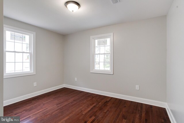 3411 Roselawn Ave, Baltimore, MD 21214 - spare room with healthy amount of natural light, dark wood-style floors, and baseboards