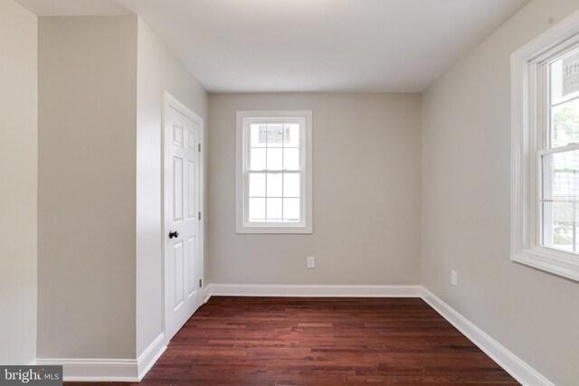 3411 Roselawn Ave, Baltimore, MD 21214 - unfurnished bedroom featuring dark wood finished floors, multiple windows, and baseboards
