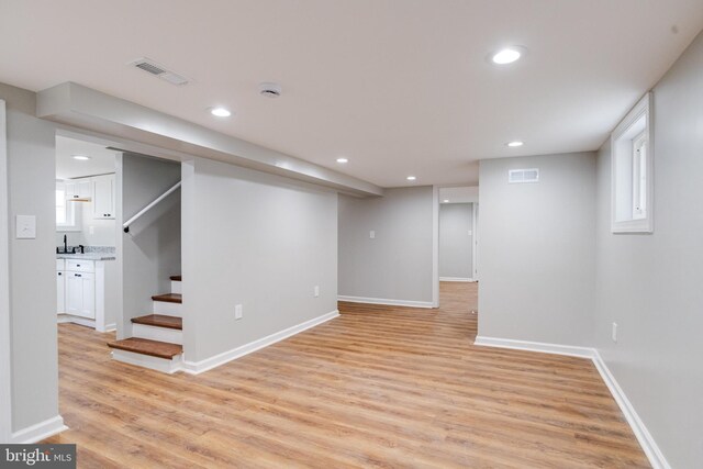 3411 Roselawn Ave, Baltimore, MD 21214 - finished below grade area with light wood-style floors, recessed lighting, stairway, and baseboards