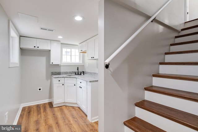 3411 Roselawn Ave, Baltimore, MD 21214 - staircase featuring wood finished floors, recessed lighting, and baseboards
