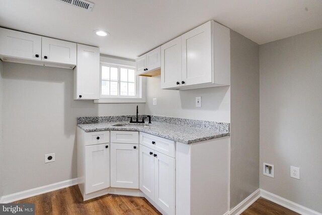 3411 Roselawn Ave, Baltimore, MD 21214 - kitchen with a sink, wood finished floors, white cabinetry, light stone counters, and baseboards