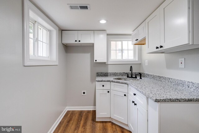 3411 Roselawn Ave, Baltimore, MD 21214 - kitchen with a sink, dark wood-type flooring, white cabinets, light stone counters, and baseboards