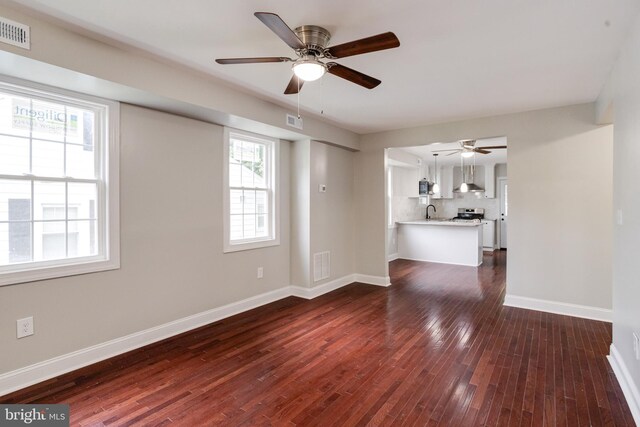 3411 Roselawn Ave, Baltimore, MD 21214 - unfurnished living room featuring dark wood-style floors, baseboards, a sink, and ceiling fan