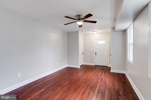 3411 Roselawn Ave, Baltimore, MD 21214 - spare room featuring dark wood-style flooring, a ceiling fan, and baseboards