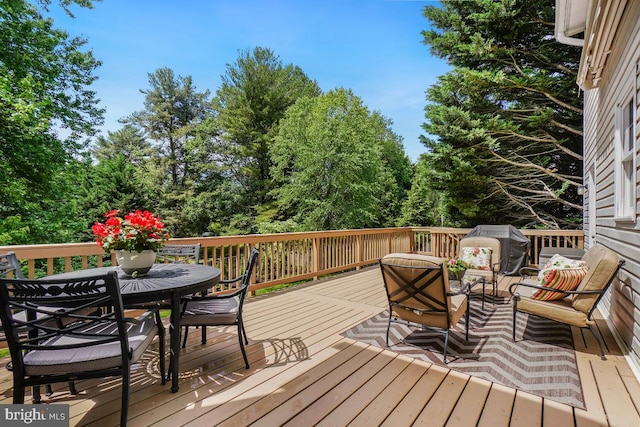 wooden deck featuring outdoor dining area