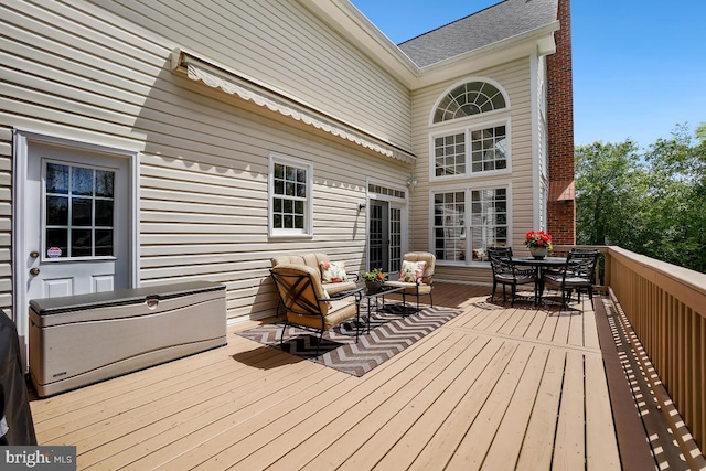 wooden terrace with outdoor dining area