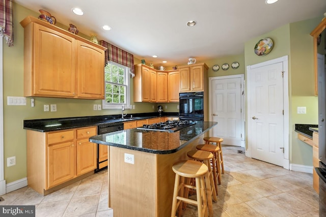 kitchen with dishwasher, a kitchen breakfast bar, stainless steel gas stovetop, a kitchen island, and a sink