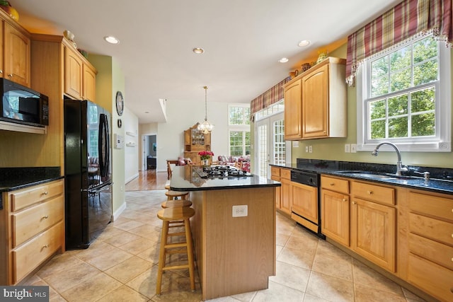 kitchen with black appliances, a sink, a center island, a chandelier, and recessed lighting