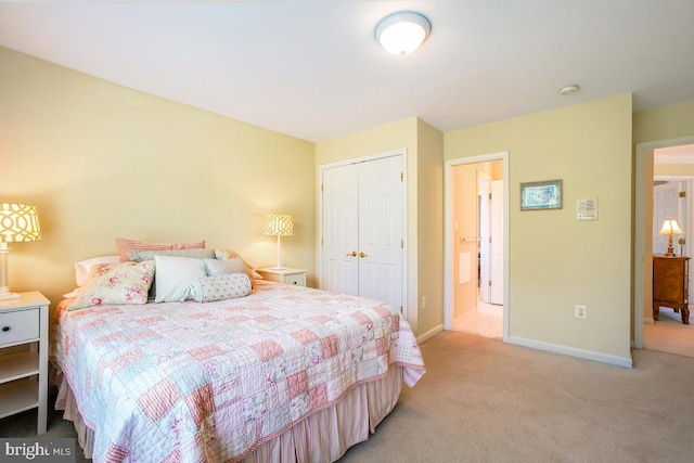 bedroom with light colored carpet, a closet, and baseboards