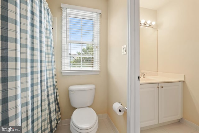 bathroom featuring baseboards, toilet, vanity, tile patterned flooring, and a shower with curtain