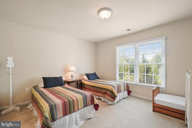 carpeted bedroom featuring baseboards