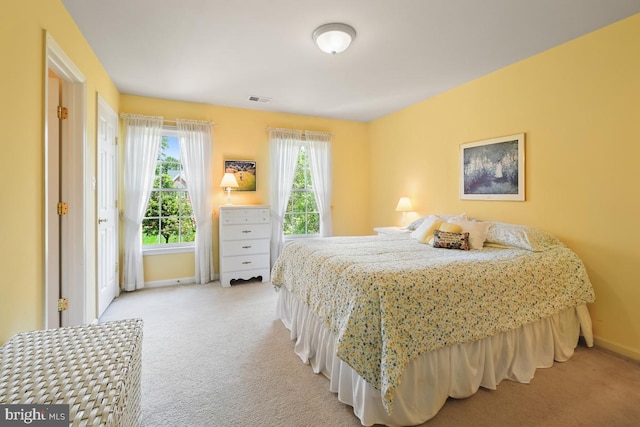 carpeted bedroom featuring baseboards