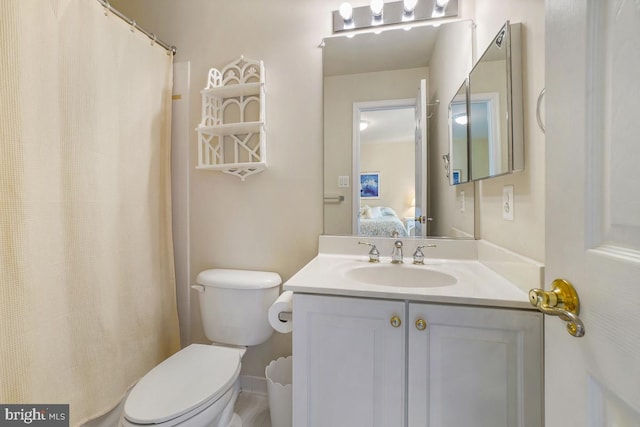 ensuite bathroom featuring vanity and toilet